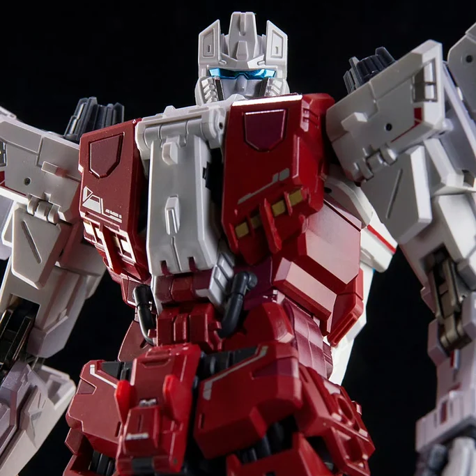 Close-up of a red and gray robot toy against a black background