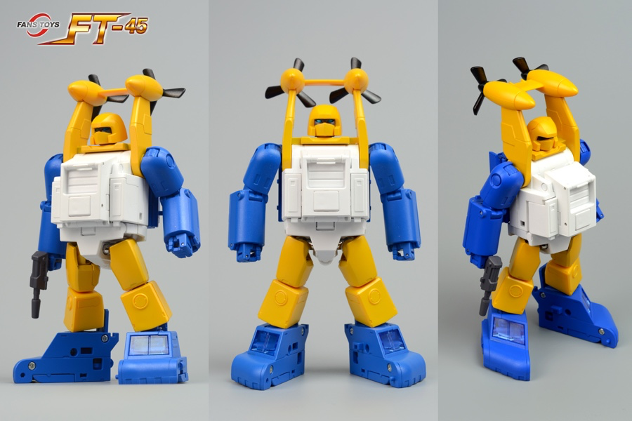 Three views of a small robot toy figure with a yellow body, blue limbs and feet, and a white chest panel, shown against a light gray background. The image includes a 'PASTY TOYS FT-45' logo in the top left and a '@FansToys' handle in the bottom right.