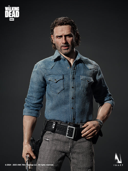A highly detailed collectible action figure of Rick Grimes from The Walking Dead, wearing a blue denim shirt and gray jeans, posed against a dark studio background with The Walking Dead and InArt logos visible.