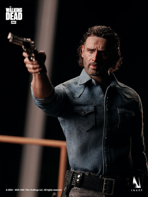 A collectible action figure of Rick Grimes from The Walking Dead, posed holding a pistol, wearing a blue denim shirt and dark pants against a dark studio background.