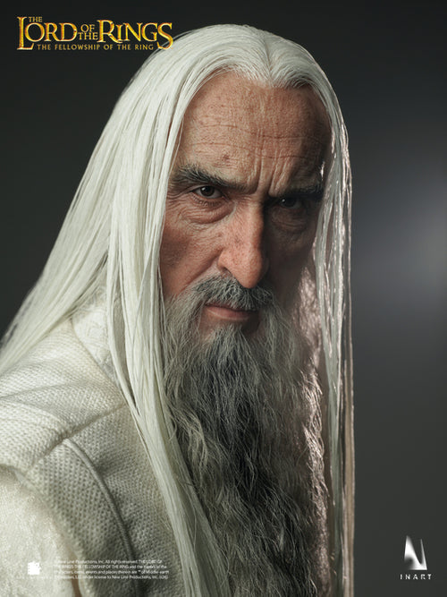 A close-up portrait of a collectible figure or statue resembling a white-clothed wizard from The Lord of the Rings: The Fellowship of the Ring, with long white hair, gray beard, and a dark gray background. The Lord of the Rings logo appears at the top left, and an InArt logo appears at the bottom right.