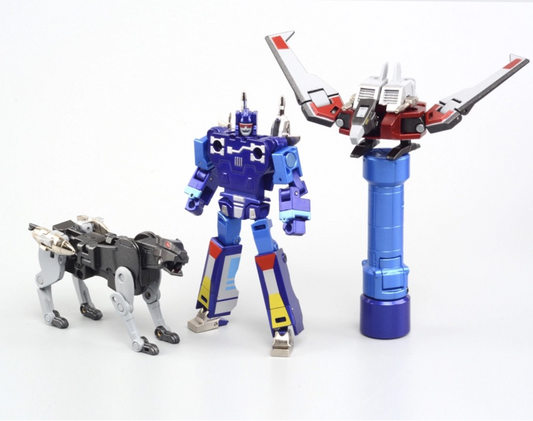 Transformers toy set from Robot Paradise featuring a blue robot figure, a black-and-white dog-like mini figure, a blue-and-black tower structure, and an orange-and-gray box component, all displayed on a white background with the model name RP-01B.